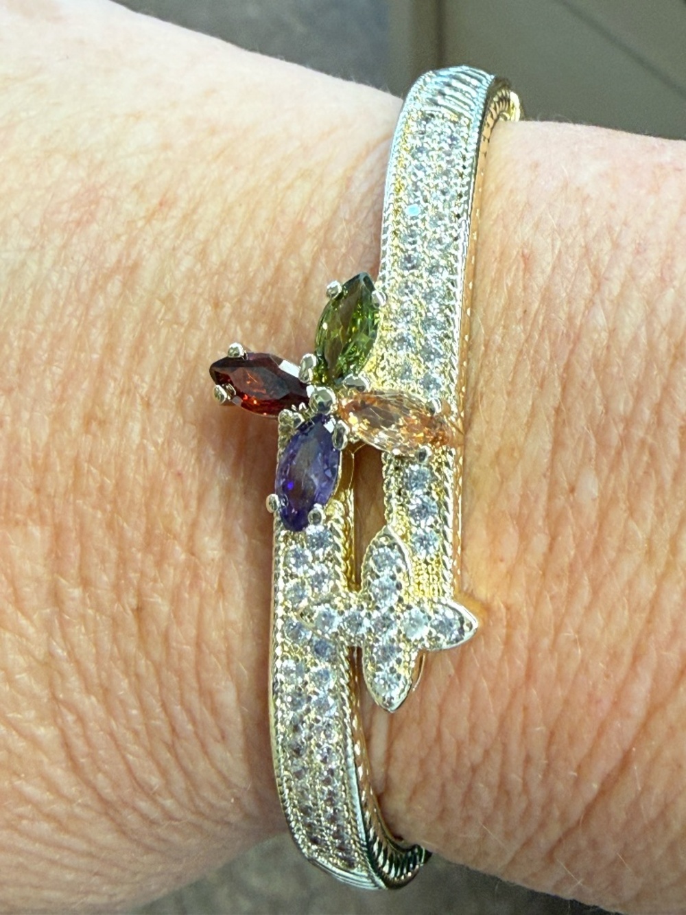 Gold bangle with multicolored CZ stones and pave clover accent